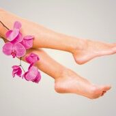 A woman 's legs with pink flowers in them.