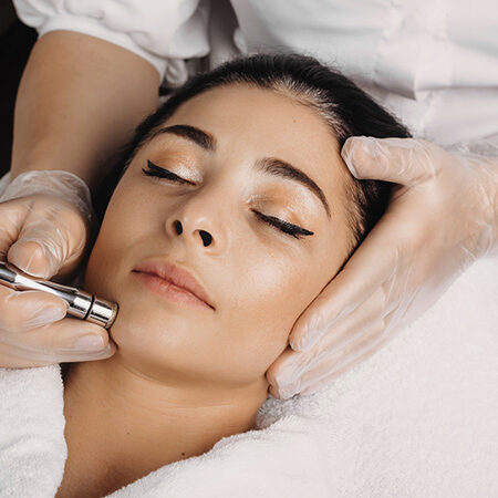 A woman getting her face waxed at the spa