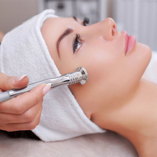 A woman getting her face waxed at the spa